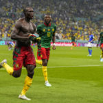 
              Cameroon's Vincent Aboubakar, left, celebrates after scoring the opening goal during the World Cup group G soccer match between Cameroon and Brazil, at the Lusail Stadium in Lusail, Qatar, Friday, Dec. 2, 2022. (AP Photo/Andre Penner)
            