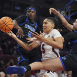
              South Carolina forward Victaria Saxton (5) battles for the ball with Memphis forward Hannah Riddick (1) and Emani Jefferson (5) during the first half of an NCAA college basketball game Saturday, Dec. 3, 2022, in Columbia, S.C. (AP Photo/Sean Rayford)
            