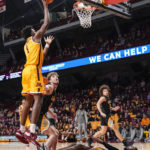 Minnesota forward Joshua Ola-Joseph (1) is called for charging as he goes up for a shot and colliding with Arkansas-Pine Bluff guard Shaun Doss Jr., right, during the first half of an NCAA college basketball game on Wednesday, Dec. 14, 2022, in Minneapolis. (AP Photo/Craig Lassig)
