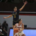 
              Virginia Tech's Georgia Amoore (5) looks to pass while guarded by Notre Dame's Sonia Citron (11) in the first half of an NCAA college basketball game in Blacksburg, Va., Sunday, Dec. 18, 2022. (Matt Gentry/The Roanoke Times via AP)
            
