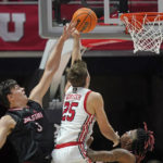 Utah guard Rollie Worster (25) goes to the basket as Jacksonville State center Maros Zeliznak (3) defends during the first half of an NCAA college basketball game Thursday, Dec. 8, 2022, in Salt Lake City. (AP Photo/Rick Bowmer)
