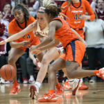 
              Indiana guard Sydney Parrish, center, goes after a loose ball between Illinois defenders Adalia McKenzie, left, and Makira Cook in the second half of an NCAA college basketball game in Bloomington, Ind., Sunday, Dec. 4, 2022. Indiana won 65-61. (AP Photo/AJ Mast)
            