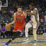 Chicago Bulls guard Zach LaVine (8) is guarded by Sacramento Kings guard Davion Mitchell (15) during the first quarter of an NBA basketball game in Sacramento, Calif., Sunday, Dec. 4, 2022. (AP Photo/Randall Benton)