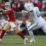 
              San Francisco 49ers quarterback Brock Purdy, left, passes against Miami Dolphins defensive tackle Zach Sieler during the first half of an NFL football game in Santa Clara, Calif., Sunday, Dec. 4, 2022. (AP Photo/Jed Jacobsohn)
            