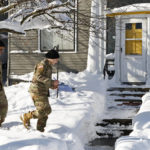 
              National guard members check on residents, Wednesday, Dec. 28, 2022, in Buffalo N.Y., following a winter storm. (AP Photo/Jeffrey T. Barnes)
            