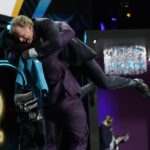Utah linebacker Devin Lloyd lifts NFL Commissioner Roger Goodell after being chosen by the Jacksonville Jaguars with the 27th pick of the NFL football draft Thursday, April 28, 2022, in Las Vegas. (AP Photo/John Locher)