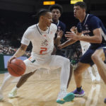 Virginia guard Reece Beekman, center and forward Kadin Shedrick (21) defends Miami guard Isaiah Wong (2) during the first half of an NCAA college basketball game, Tuesday, Dec. 20, 2022, in Coral Gables, Fla. (AP Photo/Marta Lavandier)