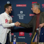 
              Newly acquired Philadelphia Phillies shortstop Trea Turner, left, shakes hands with Phillies president of baseball operations David Dombrowski during an introductory news conference, Thursday, Dec. 8, 2022, in Philadelphia. (AP Photo/Matt Slocum)
            