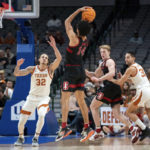 
              Stanford forward Spencer Jones (14) shoots a 3-pointer over Texas forward Christian Bishop (32) during the first half of an NCAA college basketball game, Sunday, Dec. 18, 2022, in Dallas. (AP Photo/Jeffrey McWhorter)
            