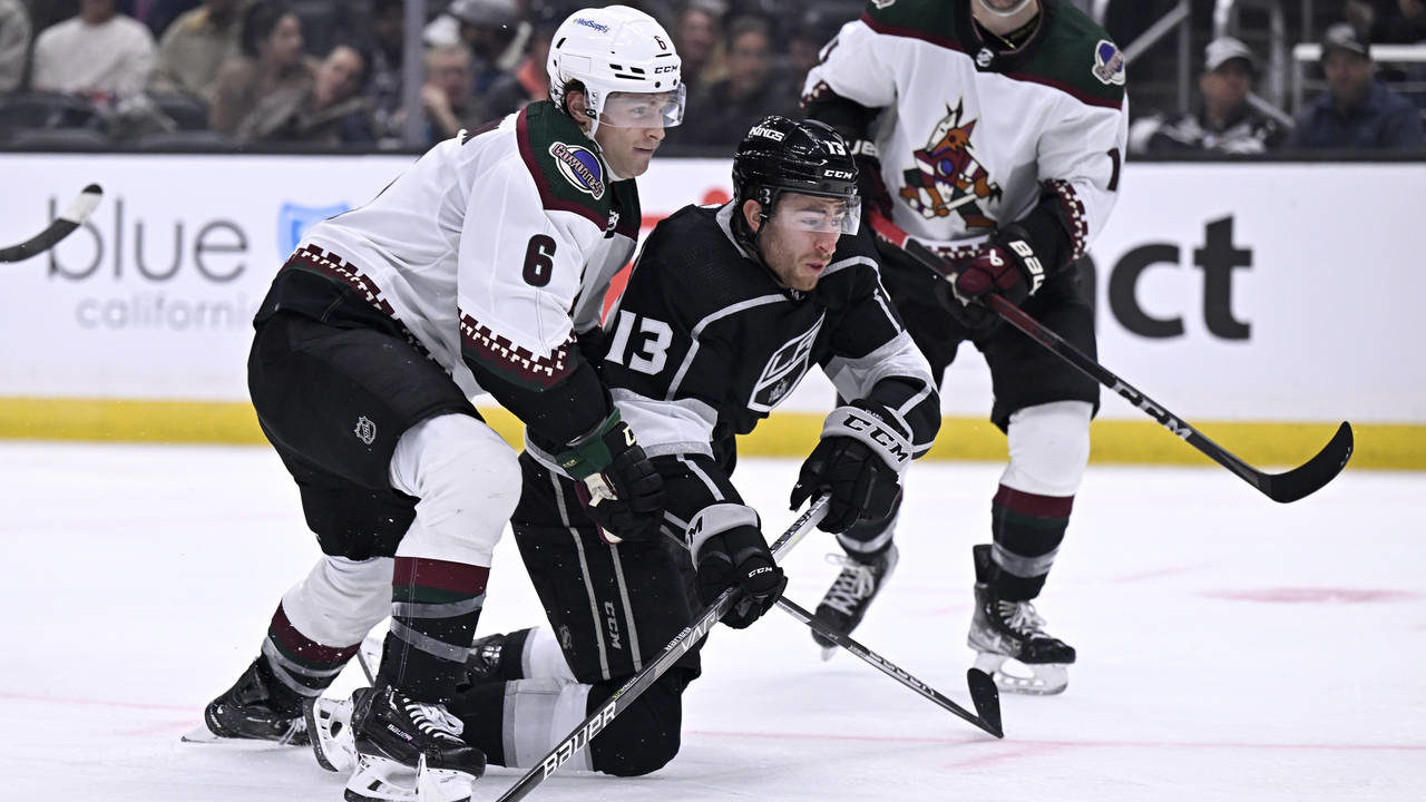 Los Angeles Kings right wing Gabriel Vilardi (13) tries to get a shot off with Arizona Coyotes defe...