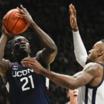 
              Connecticut forward Adama Sanogo (21) shoots over Butler center Manny Bates (15) in the second half of an NCAA college basketball game in Indianapolis, Saturday, Dec. 17, 2022. (AP Photo/AJ Mast)
            