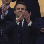 
              French President Emmanuel Macron applauds during the World Cup semifinal soccer match between France and Morocco at the Al Bayt Stadium in Al Khor, Qatar, Wednesday, Dec. 14, 2022. (AP Photo/Manu Fernandez)
            