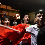 Morocco fans celebrate as they watch their team win the match against Spain at the World Cup soccer match tournament in Qatar, in Tudela, northern Spain, Tuesday, Dec. 6, 2022. (AP Photo/Alvaro Barrientos)