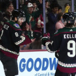 Arizona Coyotes center Nick Schmaltz (8) celebrates his goal against the Boston Bruins with right wing Clayton Keller (9) during the third period of an NHL hockey game in Tempe, Ariz., Friday, Dec. 9, 2022. The Coyotes won 4-3. (AP Photo/Ross D. Franklin)