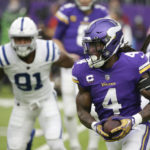 Minnesota Vikings running back Dalvin Cook (4) runs from Indianapolis Colts defensive end Yannick Ngakoue (91) during the first half of an NFL football game, Saturday, Dec. 17, 2022, in Minneapolis. (AP Photo/Andy Clayton-King)