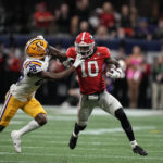 Georgia wide receiver Kearis Jackson (10) stiff arms LSU safety Major Burns (28) first half of the Southeastern Conference championship NCAA college football game, Saturday, Dec. 3, 2022, in Atlanta. (AP Photo/Brynn Anderson)