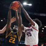 
              California's ND Okafor (22) battles for a rebound with Arizona's Cedrick Henderson (45) during the first half of an NCAA college basketball game, Sunday, Dec. 4, 2022, in Tucson, Ariz. (AP Photo/Darryl Webb)
            