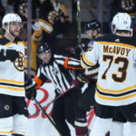 Boston Bruins right wing David Pastrnak (88) celebrates his goal against the Arizona Coyotes with Bruins Charlie McAvoy (73) during the first period of an NHL hockey game in Tempe, Ariz., Friday, Dec. 9, 2022. (AP Photo/Ross D. Franklin)