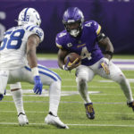 Minnesota Vikings running back Dalvin Cook (4) runs from Indianapolis Colts linebacker Bobby Okereke (58) during overtime in an NFL football game, Saturday, Dec. 17, 2022, in Minneapolis. The Vikings won 39-36. (AP Photo/Andy Clayton-King)