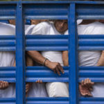 
              Men who were detained under a state of exception, are transported in a livestock trailer to a detention center in Soyapango, El Salvador, on Oct. 7, 2022. (AP Photo/Moises Castillo)
            