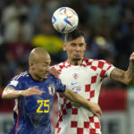 Croatia's Dejan Lovren, right, and Japan's Daizen Maeda go for a header during the World Cup round of 16 soccer match between Japan and Croatia at the Al Janoub Stadium in Al Wakrah, Qatar, Monday, Dec. 5, 2022. (AP Photo/Francisco Seco)