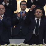 
              French President Emmanuel Macron is flanked by FIFA President Gianni Infantino during the World Cup semifinal soccer match between France and Morocco at the Al Bayt Stadium in Al Khor, Qatar, Wednesday, Dec. 14, 2022. (AP Photo/Manu Fernandez)
            