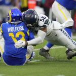 
              Los Angeles Rams quarterback John Wolford (13) is sacked by Seattle Seahawks linebacker Jordyn Brooks (56) for a 10-yard loss during the second half of an NFL football game Sunday, Dec. 4, 2022, in Inglewood, Calif. (AP Photo/Marcio Jose Sanchez)
            