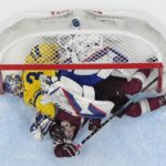 Latvia's Martins Dzierkals, bottom, winds up under Sweden goalkeeper Lars Johansson (31) after they collided during a preliminary round men's hockey game at the 2022 Winter Olympics, Thursday, Feb. 10, 2022, in Beijing. (AP Photo/Matt Slocum)