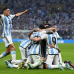 Players of Argentina celebrate with Angel Di Maria after he scored his side's second goal during the World Cup final soccer match between Argentina and France at the Lusail Stadium in Lusail, Qatar, Sunday, Dec. 18, 2022. (AP Photo/Natacha Pisarenko)