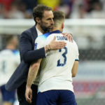 
              England's head coach Gareth Southgate embraces England's Luke Shaw at the end of the World Cup quarterfinal soccer match between England and France, at the Al Bayt Stadium in Al Khor, Qatar, Sunday, Dec. 11, 2022. France won 2-1. (AP Photo/Francisco Seco)
            