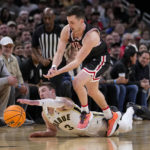 Purdue guard Braden Smith (3) drives for the ball past Davidson guard Foster Loyer (0) in the first half of an NCAA college basketball game in Indianapolis, Saturday, Dec. 17, 2022. (AP Photo/Michael Conroy)