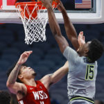 
              Baylor forward Josh Ojianwuna (15) dunks as Washington State forward DJ Rodman (11) defends during an NCAA college basketball game on Sunday, Dec. 18, 2022, in Dallas. Baylor won 65-59. (AP Photo/Brandon Wade)
            