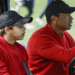 
              Tiger Woods, right, and Charlie Woods, left, drive down the 3rd fairway during the final round of the PNC Championship golf tournament Sunday, Dec. 18, 2022, in Orlando, Fla. (AP Photo/Kevin Kolczynski)
            
