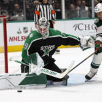 Dallas Stars goaltender Jake Oettinger (29) defends the goal against Minnesota Wild right wing Ryan Reaves (75) during the second period of an NHL hockey game in Dallas, Sunday, Dec. 4, 2022. (AP Photo/LM Otero)