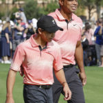 
              Tiger Woods and his son Charlie Woods walk down the fairway of the first hole during the first round of the PNC Championship golf tournament Saturday, Dec. 17, 2022, in Orlando, Fla. (AP Photo/Kevin Kolczynski)
            