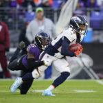 
              Baltimore Ravens cornerback Kevon Seymour (25) tackles Denver Broncos wide receiver Montrell Washington (12) on a punt return in the second half of an NFL football game, Sunday, Dec. 4, 2022, in Baltimore. (AP Photo/Patrick Semansky)
            