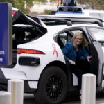 
              Phoenix Mayor Kate Gallego arrives in a self-driving vehicle, Friday, Dec. 16, 2022, at the Sky Harbor International Airport Sky Train facility in Phoenix. Mayor Gallego announced Friday that Sky Harbor will be the first airport to have self-driving, ride-hailing service Waymo available. A test group has been using Waymo vehicles from the airport's sky train to downtown Phoenix since early November.(AP Photo/Matt York)
            