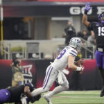 Kansas State quarterback Will Howard (18) is pressured by TCU defensive lineman Dylan Horton (98) and linebacker Shadrach Banks (19) in the first half of the Big 12 Conference championship NCAA college football game, Saturday, Dec. 3, 2022, in Arlington, Texas. (AP Photo/LM Otero)