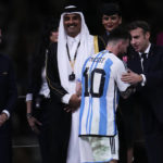 
              Argentina's Lionel Messi is congratulated by French President Emmanuel Macron as FIFA President Gianni Infantino and The Emir of Qatar Sheikh Tamim bin Hamad Al Thani look on, after winning the World Cup final soccer match between Argentina and France at the Lusail Stadium in Lusail, Qatar, Sunday, Dec.18, 2022. (AP Photo/Manu Fernandez)
            