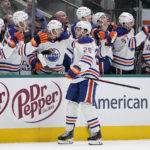 Edmonton Oilers center Mattias Janmark (26) celebrates with the bench after scoring against the Dallas Stars in the first period of an NHL hockey game, Wednesday, Dec. 21, 2022, in Dallas. (AP Photo/Tony Gutierrez)