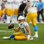 
              Los Angeles Chargers quarterback Justin Herbert (10) reacts after being tackled during the first half of an NFL football game against the Las Vegas Raiders, Sunday, Dec. 4, 2022, in Las Vegas. (AP Photo/Matt York)
            