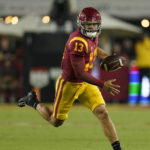 
              FILE - Southern California quarterback Caleb Williams (13) runs during the second half of an NCAA college football game against Washington State Saturday, Oct. 8, 2022, in Los Angeles. Heisman Trophy winner Caleb Williams was one of three Southern California players to be selected to The Associated Press All-America team released Monday, Dec. 12, 2022. (AP Photo/Marcio Jose Sanchez, File)
            