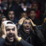 
              Moroccan fans react while watching the Morocco national team lose to France in the semi final of the World Cup played in Qatar, in Rabat, Morocco, Wednesday, Dec. 14, 2022. (AP Photo/Mosa'ab Elshamy)
            