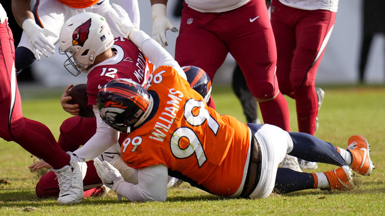 Arizona Cardinals quarterback Colt McCoy (12) is sacked by Denver Broncos defensive tackle DeShawn ...