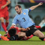 
              South Korea's Hwang Ui-jo and Uruguay's Diego Godin fall as they vie for the ball during the World Cup group H soccer match between Uruguay and South Korea, at the Education City Stadium in Al Rayyan , Qatar, Thursday, Nov. 24, 2022. (AP Photo/Frank Augstein)
            