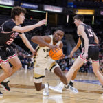 
              Purdue guard Brandon Newman (5) drives past Davidson guard Achile Spadone (20) in the first half of an NCAA college basketball game in Indianapolis, Saturday, Dec. 17, 2022. (AP Photo/Michael Conroy)
            