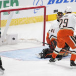 
              Dallas Stars center Roope Hintz (24) and Anaheim Ducks defenseman Dmitry Kulikov (29) and goaltender Anthony Stolarz (41) look back to see the puck, shot by Stars' Jason Robertson, enter the net for a goal in the third period of an NHL hockey game Thursday, Dec. 1, 2022, in Dallas. The score was Robertson's third of the game. (AP Photo/Tony Gutierrez)
            