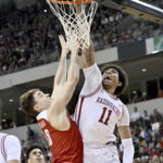 Arkansas forward Jalen Graham (11) tries to dunk the ball over Bradley guard Connor Hickman during the first half of an NCAA college basketball game, Saturday, Dec. 17, 2022, in North Little Rock, Ark. (AP Photo/Michael Woods)