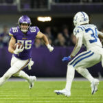 Minnesota Vikings tight end Johnny Mundt (86) runs from Indianapolis Colts cornerback Isaiah Rodgers (34) after catching a pass during overtime in an NFL football game, Saturday, Dec. 17, 2022, in Minneapolis. The Vikings won 39-36. (AP Photo/Abbie Parr)