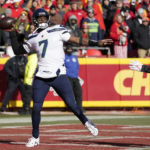 Seattle Seahawks quarterback Geno Smith (7) throws under pressure from Kansas City Chiefs defensive end Carlos Dunlap (8) during the first half of an NFL football game Saturday, Dec. 24, 2022, in Kansas City, Mo. (AP Photo/Ed Zurga)